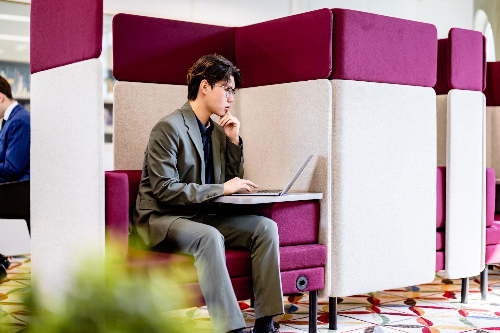 A young man working on his laptop on a remote space.